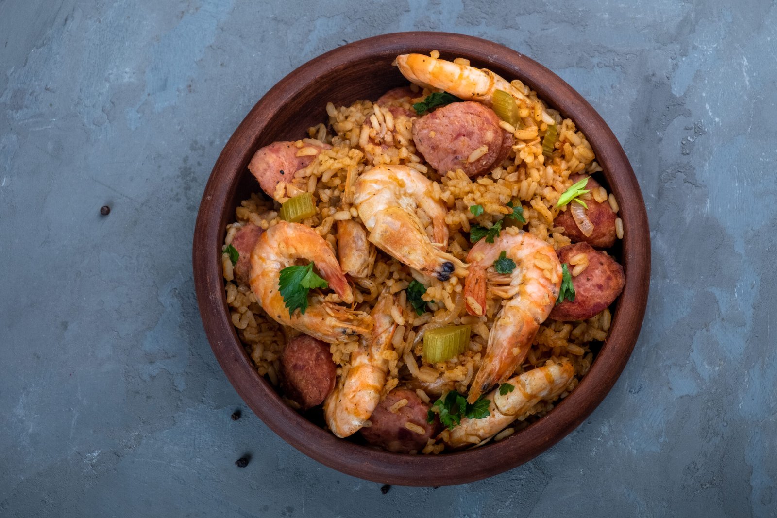 Local food jambalaya with shrimps, waffles and smoked sausages . A dish of Cajun cuisine. Top view.