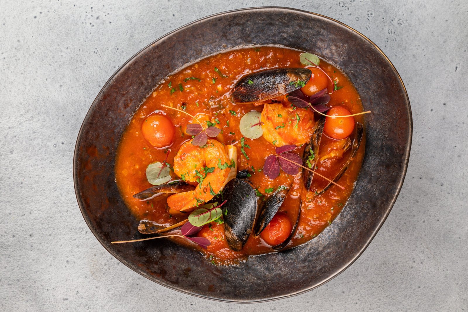 Traditional American fish stew cioppino with shrimps, fish fillets French Fish Soup Bouillabaisse