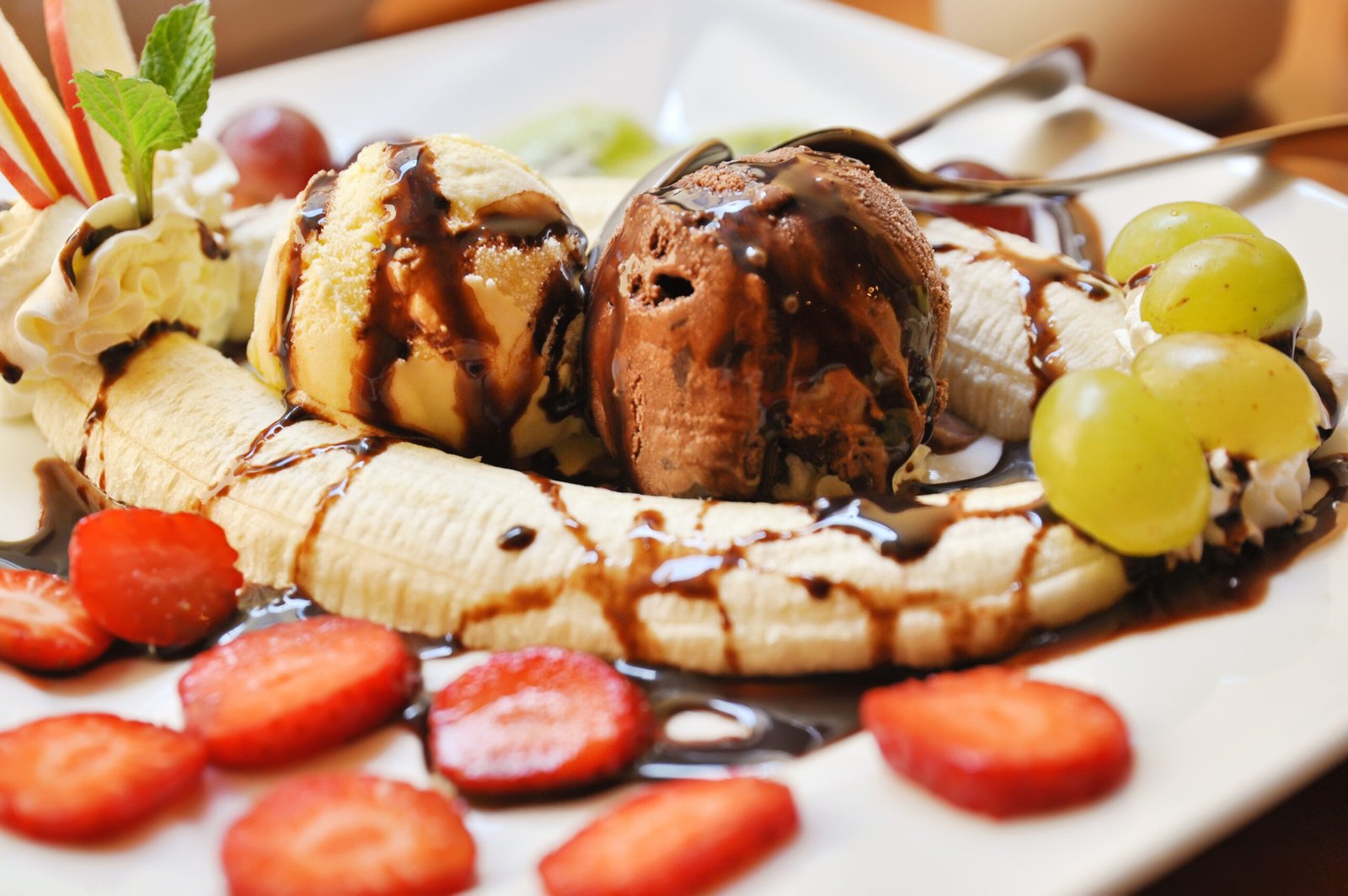 Fresh banana split with ice-cream on the dish in cafe